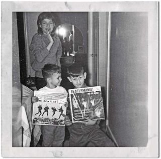 Geddy Lee as a child, holding a Beatles album
