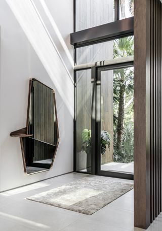 entrance with glass door in Miami home