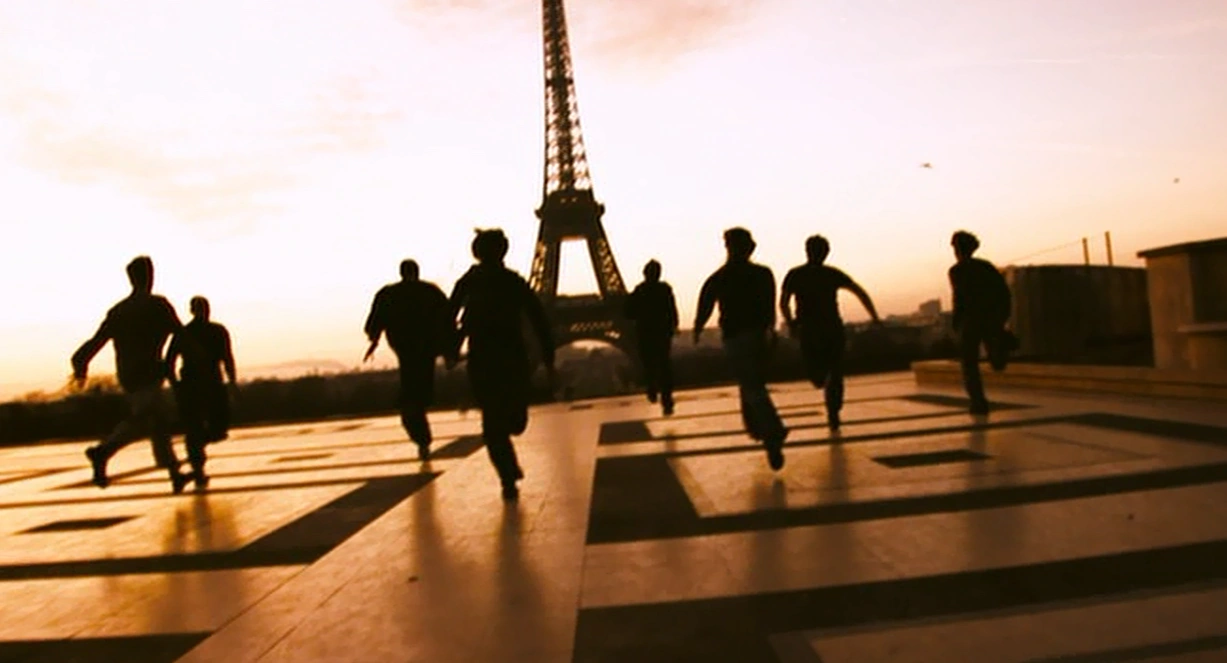 A group of zombies running with the Eiffel Tower in the background.