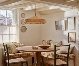 coastal cottage with a corner banquette seat and a cafe curtain at the window