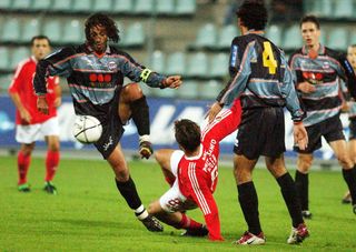 Servette's Paulo Diogo (left) attempts to clear the ball in a match against Benfica in October 2002.