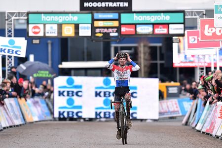Mathieu van der Poel raises his arms on the approach to the line