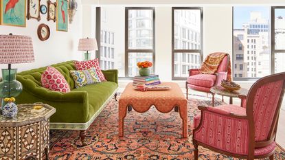 colorful living room with green sofa, pink armchair and salmon pink coffee table