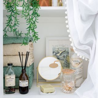 bathroom shelving with towels and toiletries