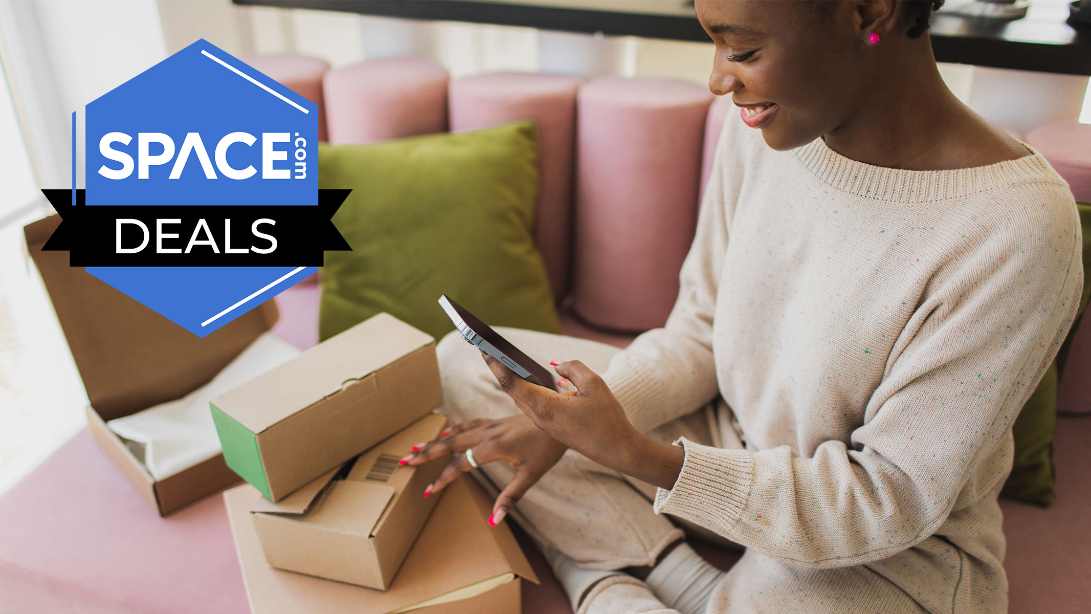 A woman looking down at her phone with packages around her. 