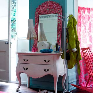 blue bedroom with feminine pink chest of drawers