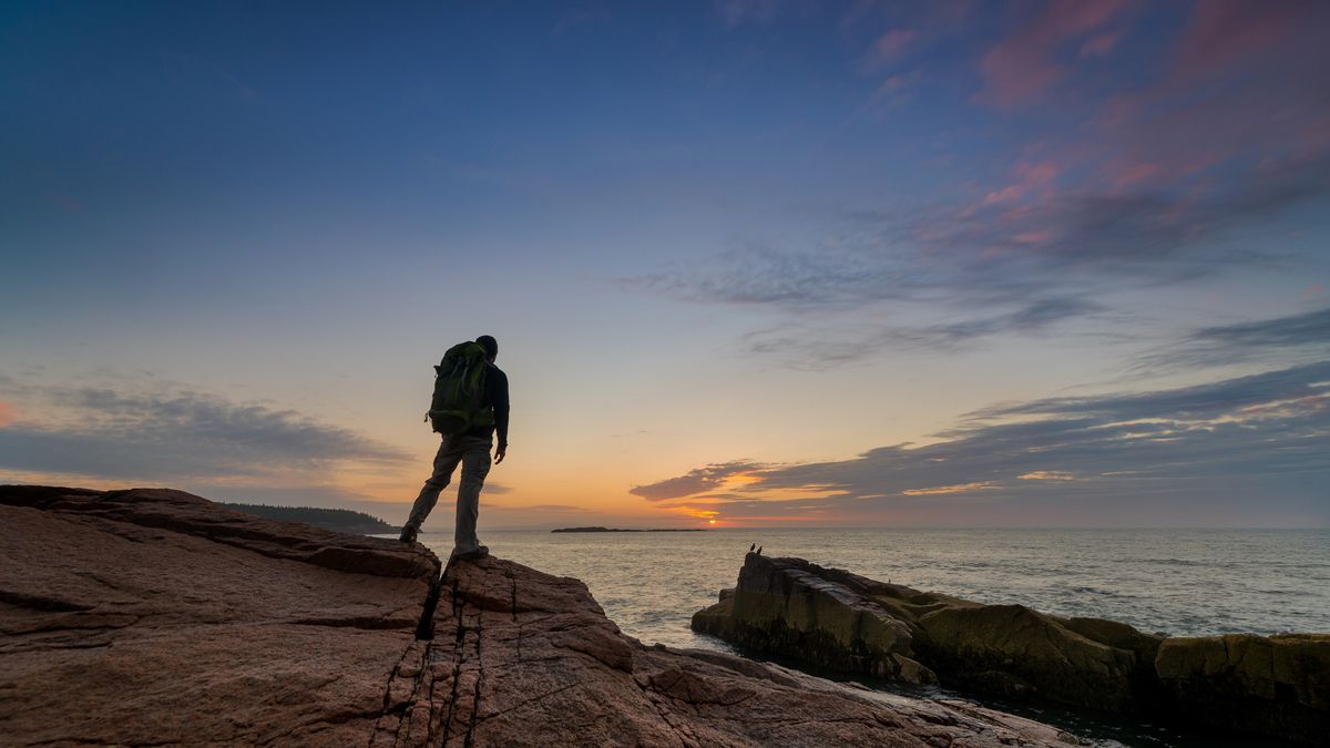 A hiker on the coast in Acadia National park