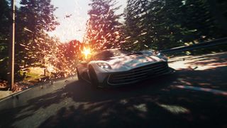 An Aston Martin Valhalla drives down a road, sparks flying from its rear.