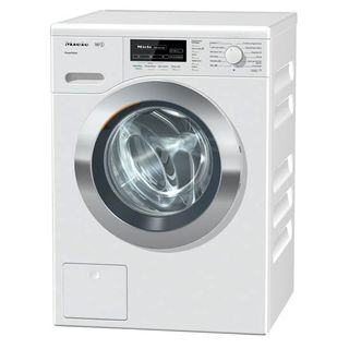 Empty Miele washing machine with digital display and knob