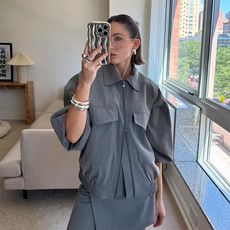 tinsley wears all gray monochromatic look while posing with chunky, stylish jewelry