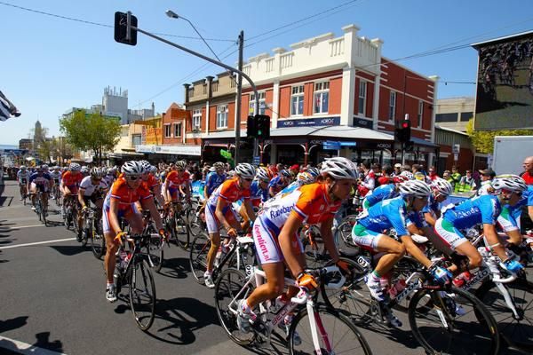 The peloton makes its way under blue skies.