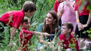 Kate Middleton talking with some schoolboys
