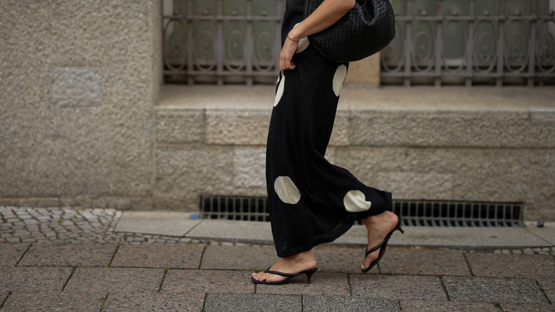 woman wearing polka dot skirt and heeled flip flops