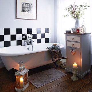 bathroom with wooden flooring and white bathtub