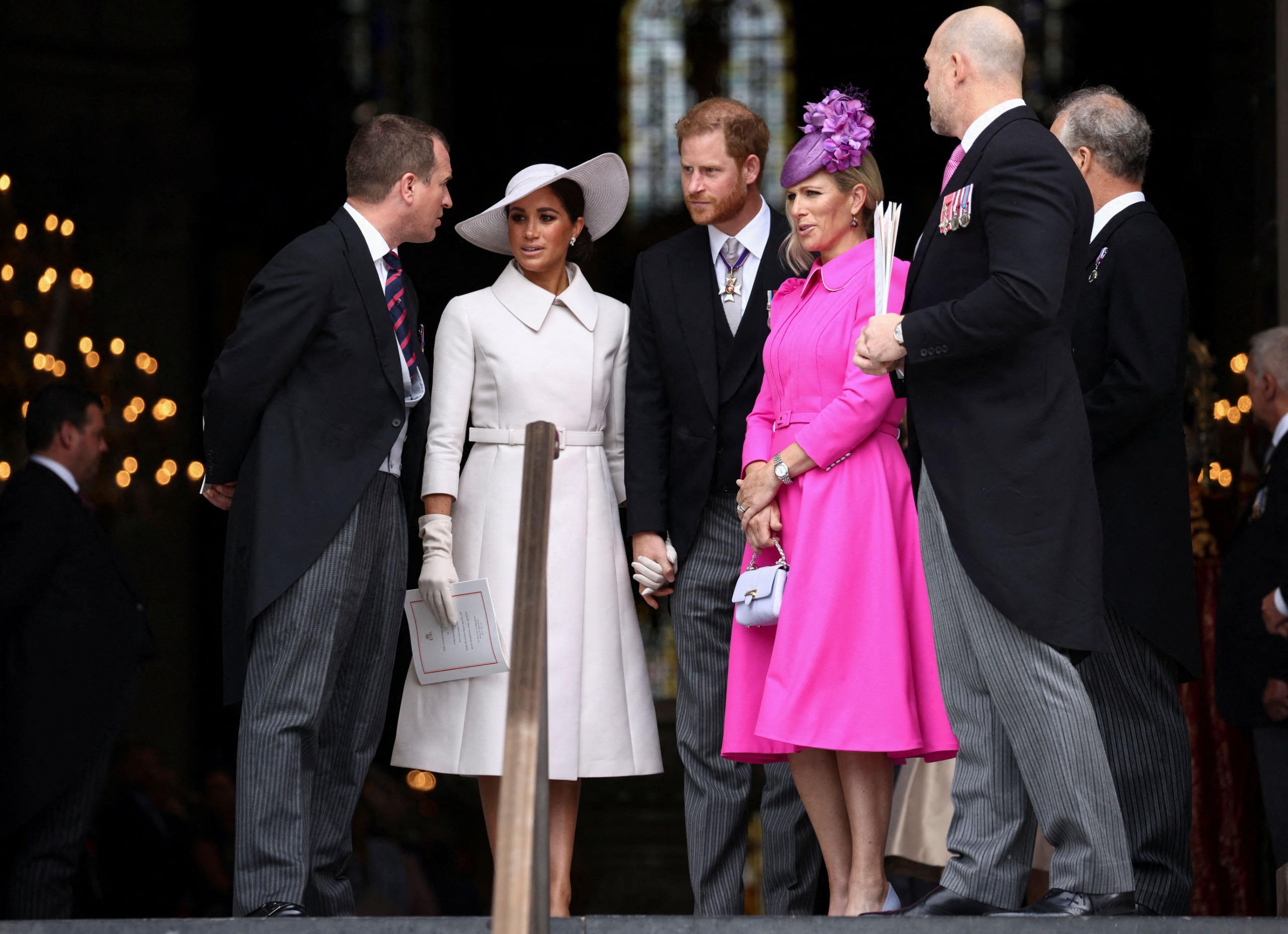 Prince Harry and Meghan Markle talking to Zara and Mike Tindall and Peter Phillips at St Paul's Cathedral