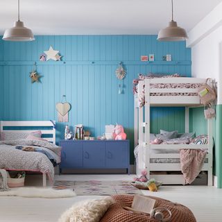 childrens room with blue wall rack bed and white flooring
