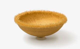 A gold-coloured mandala bowl.