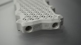 A photo of a custom cold plate for an Nvidia H100, designed and manufactured by Alloy Enterprises, after modelling the optimal fluid flow by nTop