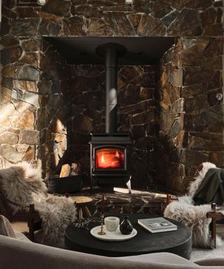 fireside seats in cabin with stone fire surround