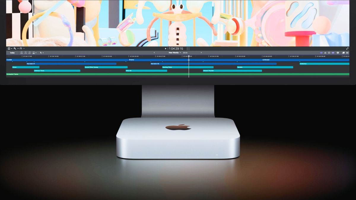 A Mac Mini in front of an iMac display with a black background