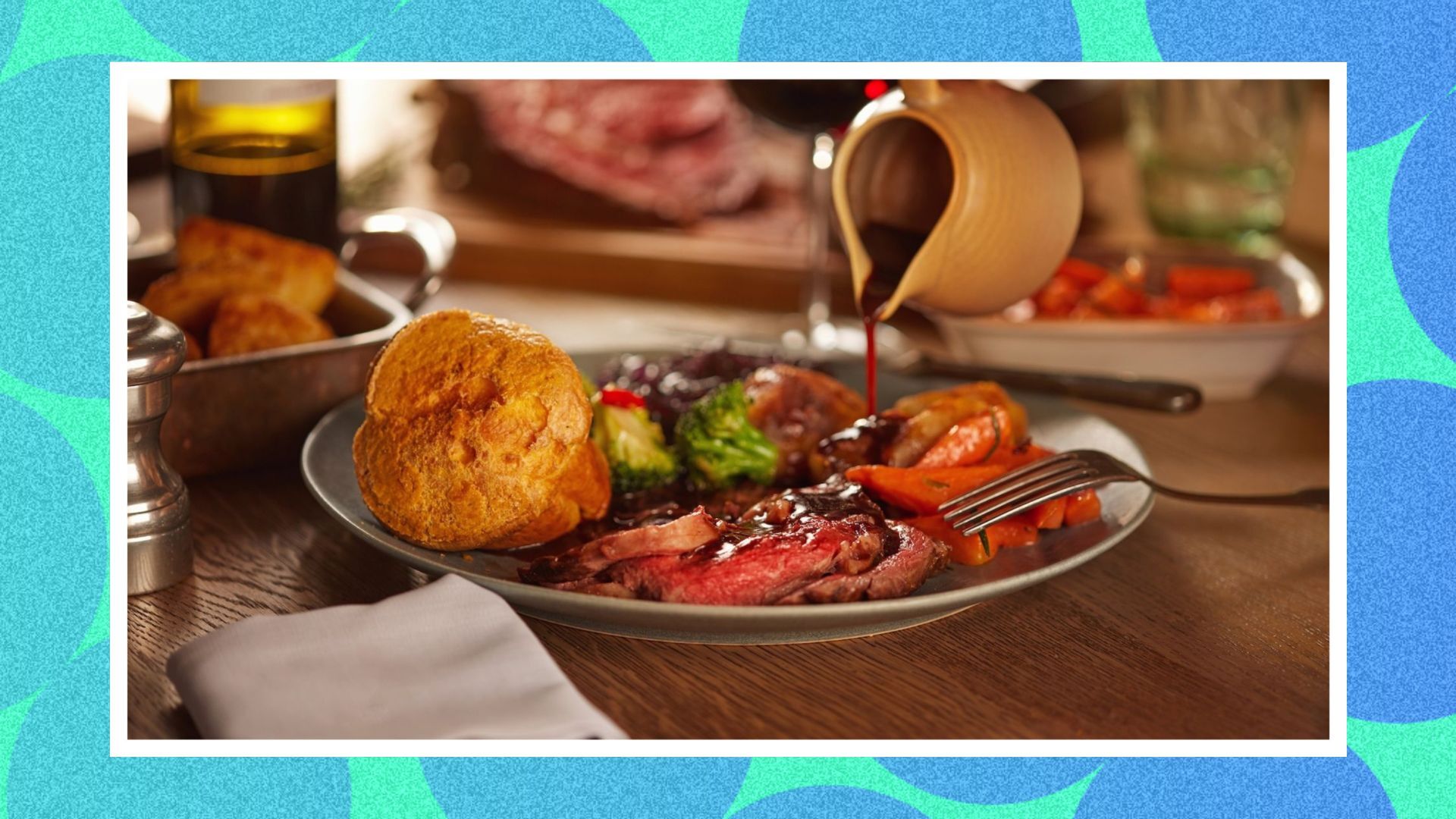 A picture of roast beef on a table, whilst having gravy poured over it. 