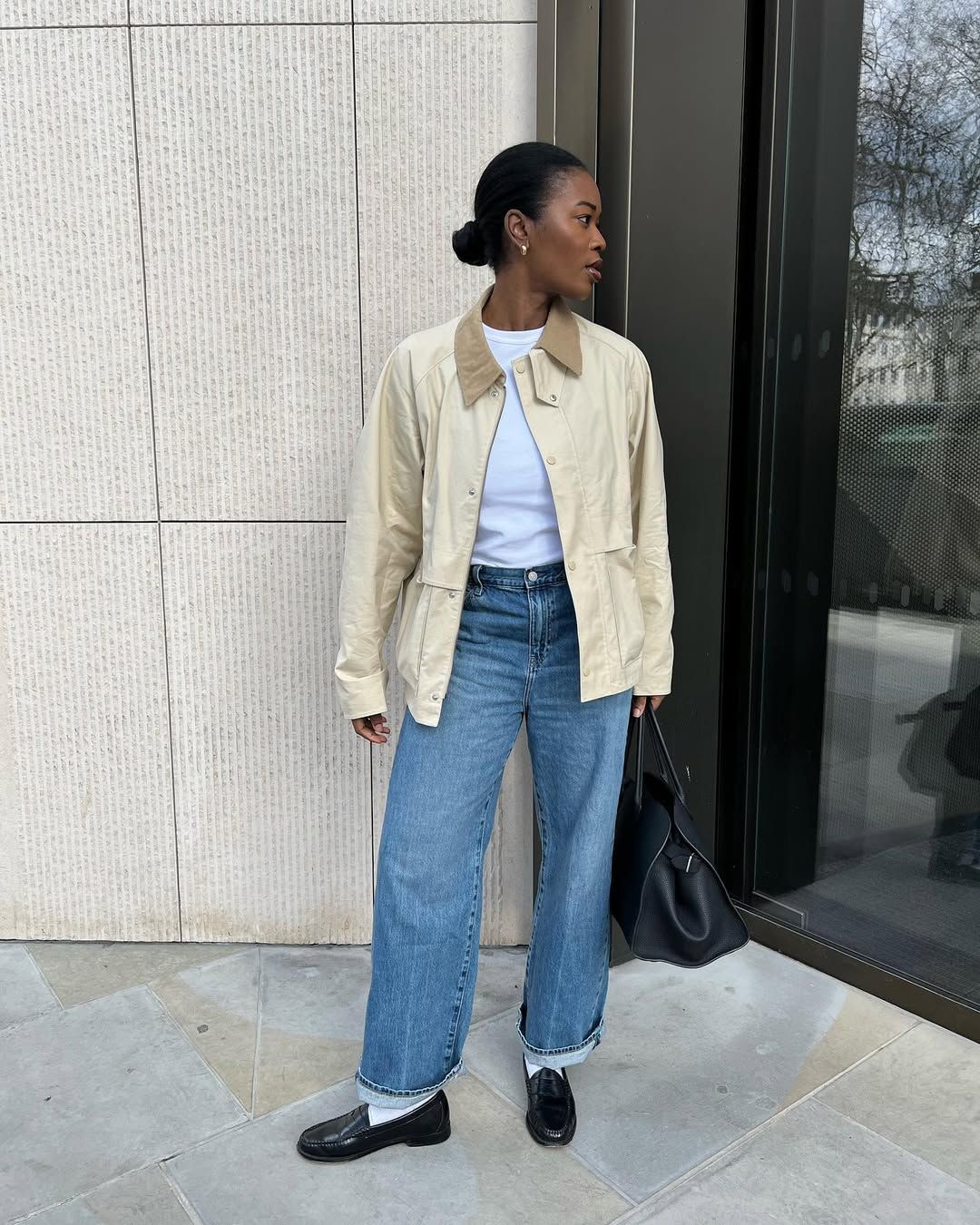 @nlmarilyn wearing a white t-shirt, barn jacket, jeans and loafers