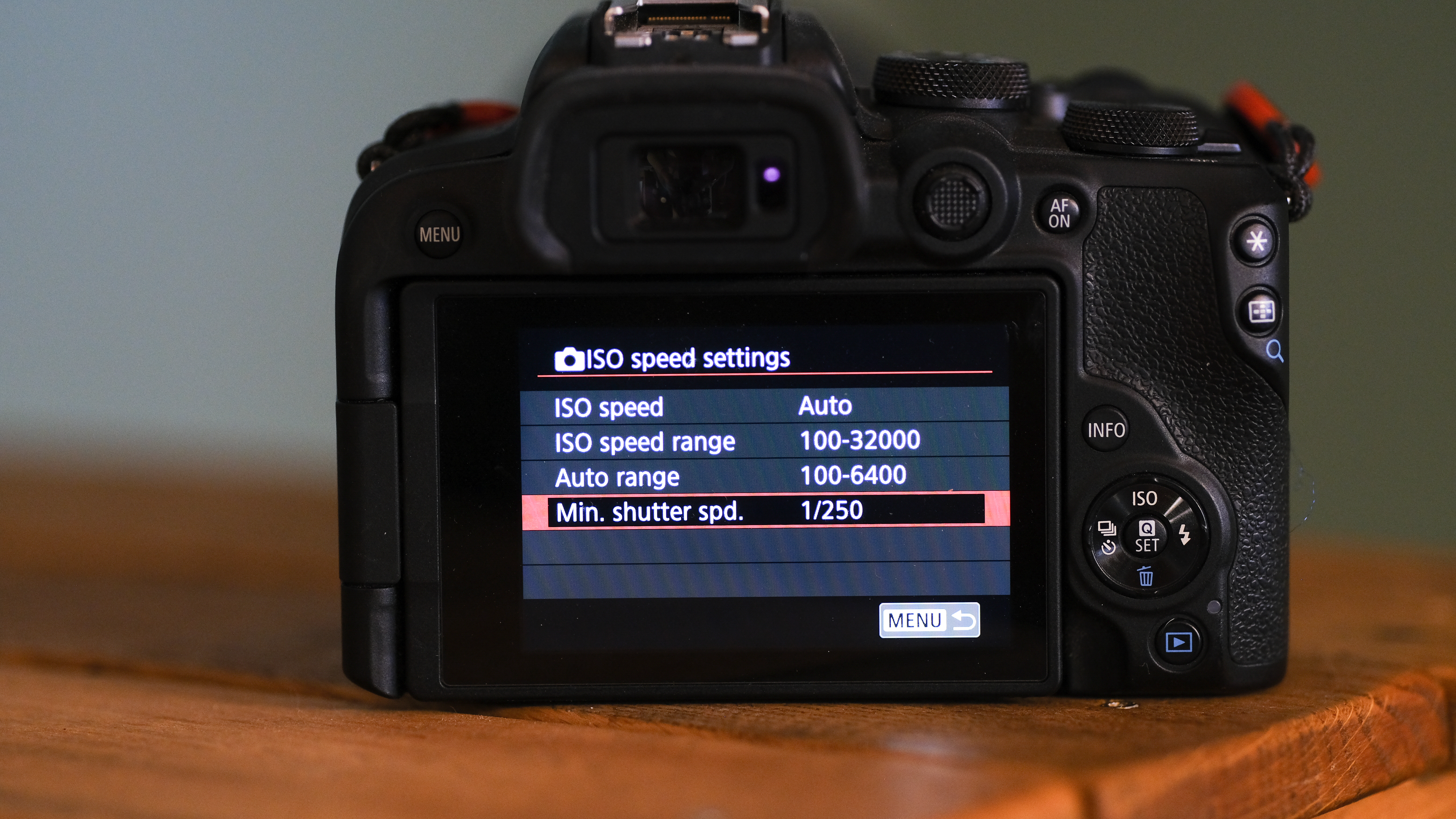A camera in aperture priority mode with a minimum shutter speed set in the camera menu