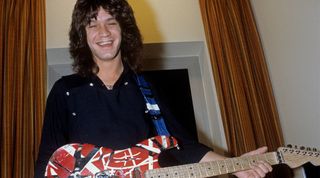 Eddie Van Halen stands holding his Frankenstein guitar in October 1981