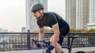 Man cycling while wearing Amazfit PowerBuds Pro