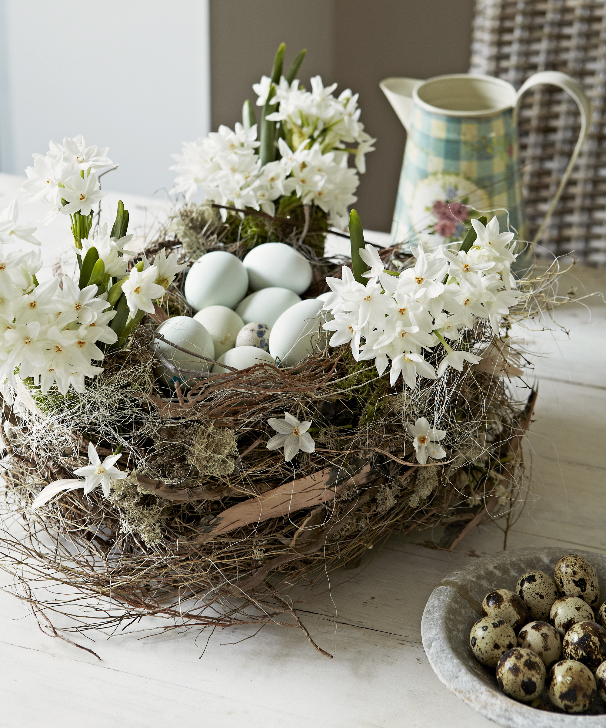 Fake bird's nest with eggs and paperwhites