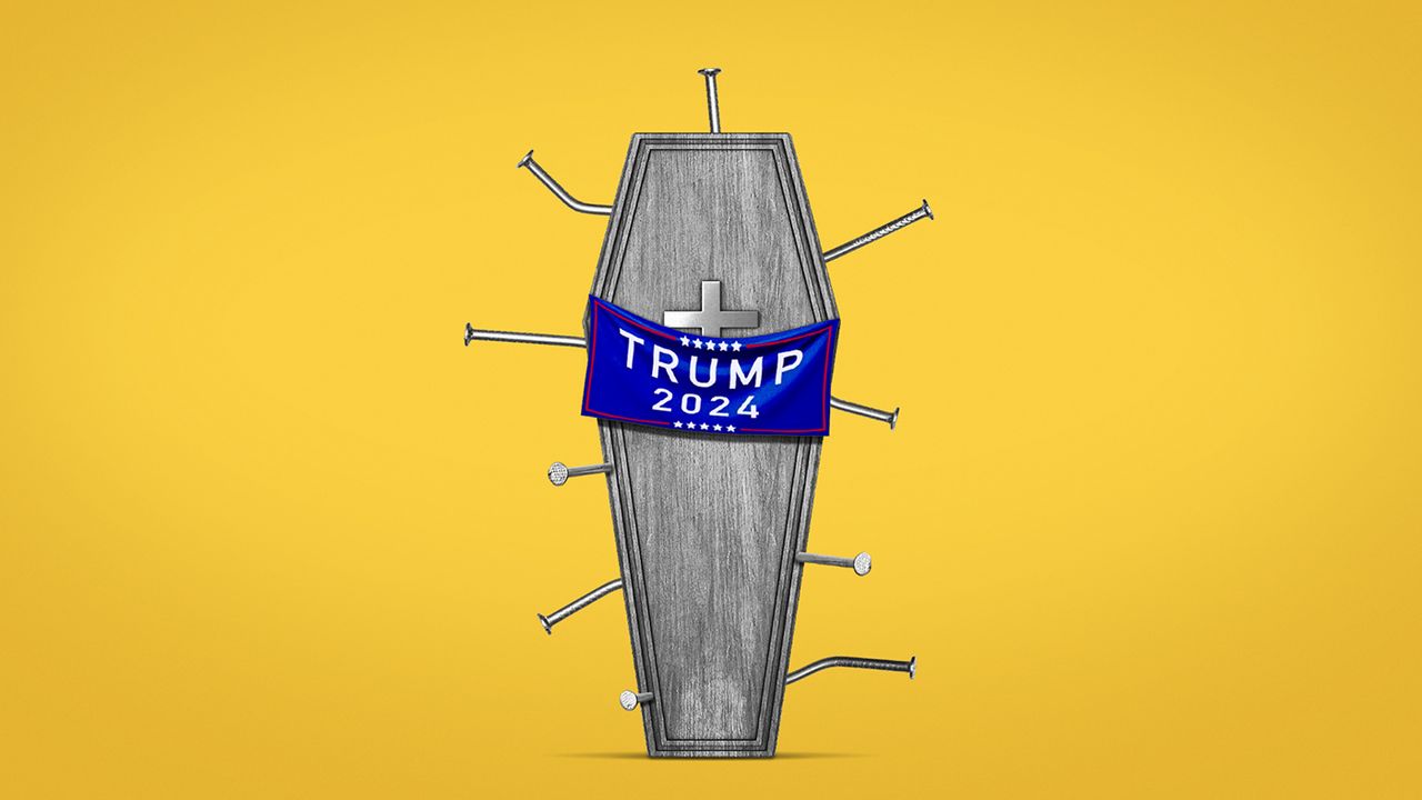 Coffin draped with a Trump banner, filled with nails