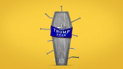 Coffin draped with a Trump banner, filled with nails