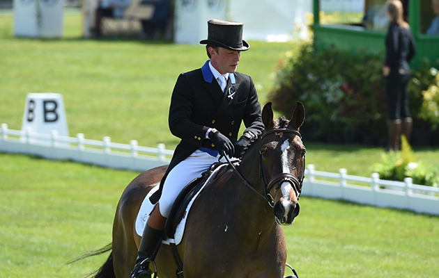 Simon Grieve who worre ribbons in memory of rider Izzy Squire as he rode Cornacrew GBR during the Dressage Phase of The Mitsubishi Motors Badminton Horse Trials at Badminton in Gloucestershire, UK on 5th May 2016