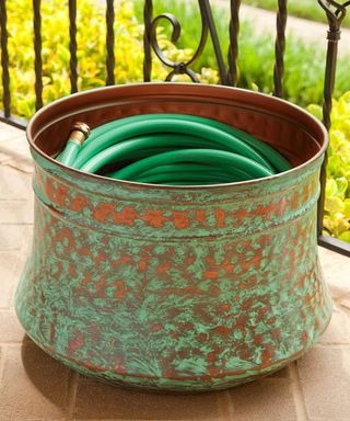 Rustic open pot to store garden hose