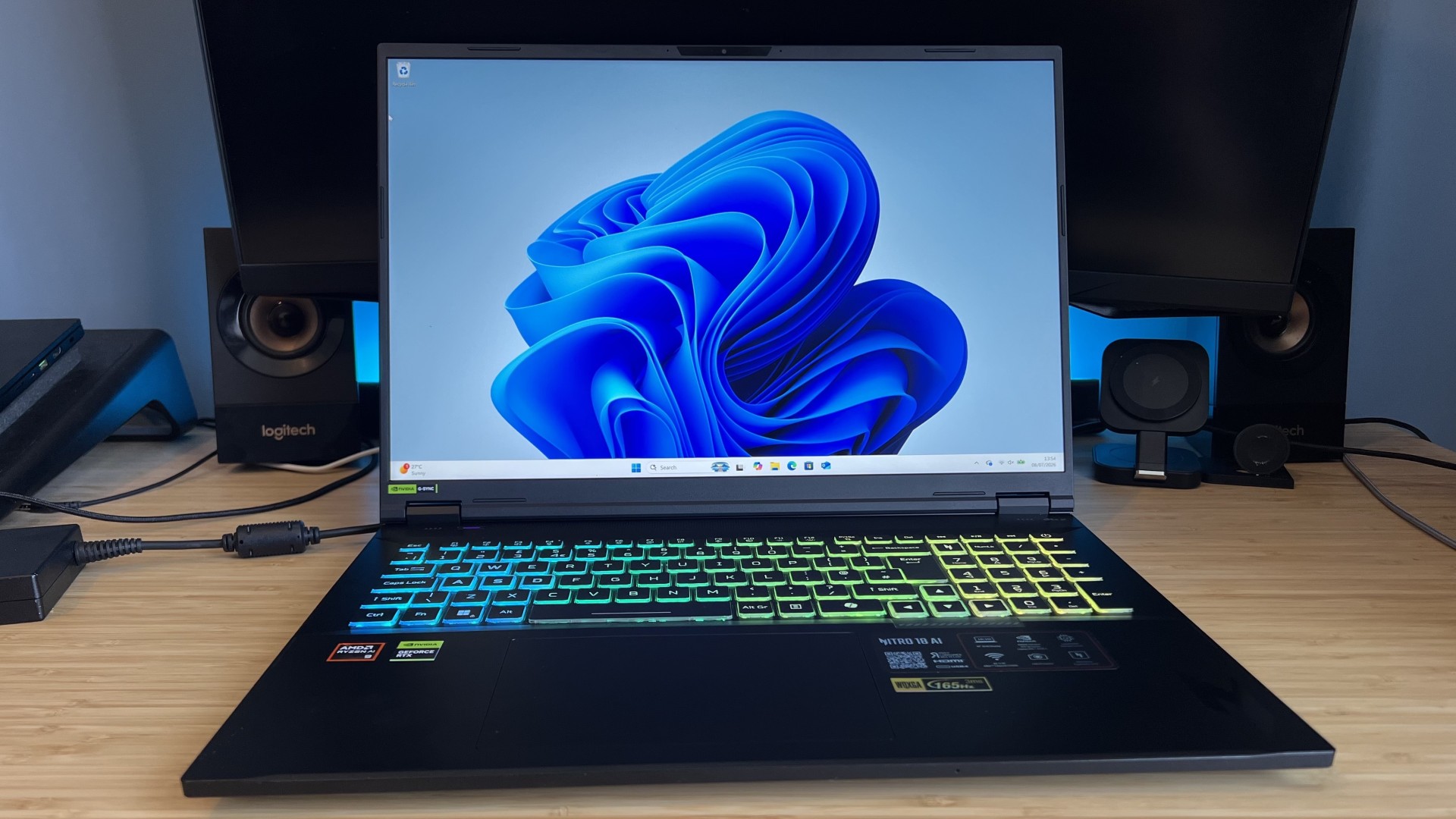 Acer Nitro 18 AI gaming laptop on a wooden desk with blue backlighting