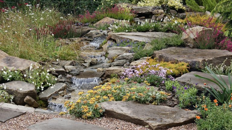 how to build a rock garden a rocky hillside dotted with colorful alpine plants in a front or back garden