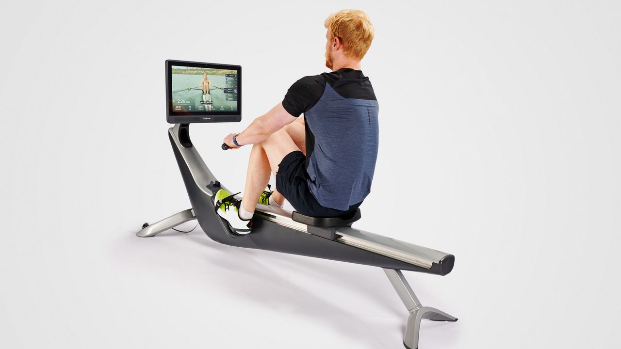 Person using Hydrow rowing machine.