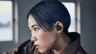 a woman wearing the audio-technica ath-cks50tw wireless earbuds