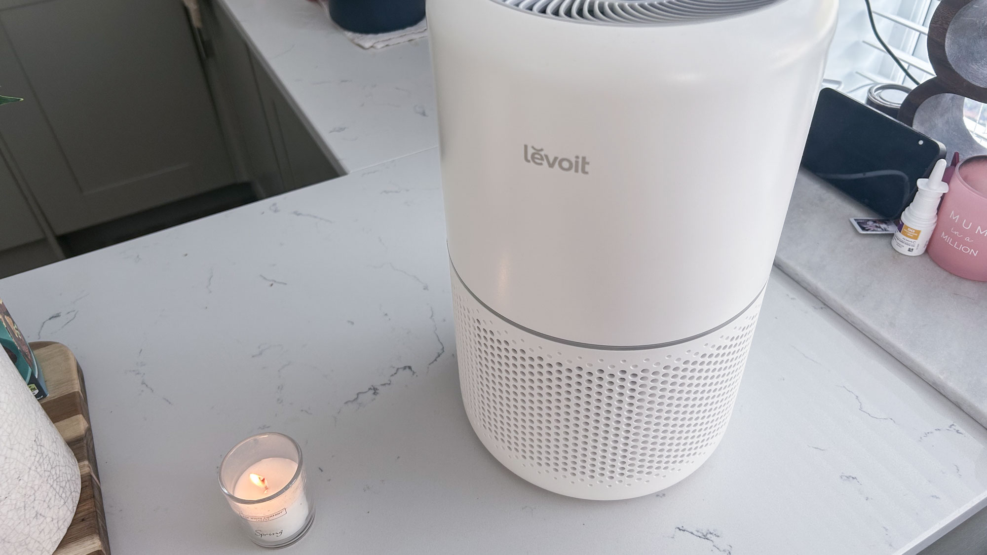 Levoit Core 300S Air purifier on table with candle