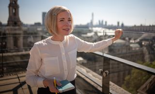 Lucy stands on a rooftop at Kings College