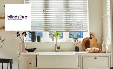Blinds2go logo top left with a picture of some blinds in a kitchen 