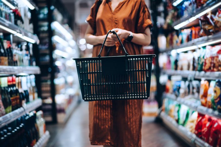 young woman carrying a shopping basket