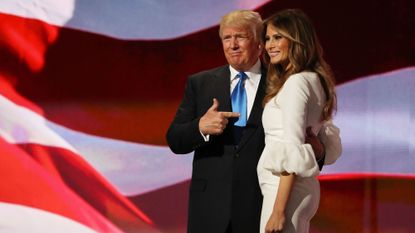 Red, Coat, Suit, Formal wear, Interaction, Suit trousers, Tie, Gesture, Flag, Love, 