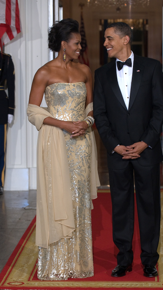 Michelle Obama and Barack Obama shortly before greeting Indian Prime Minister Manmohan Singh and his wife Gursharan Kaur at the North Portico of the White House November 24, 2009, as the Obamas host their first official State Dinner