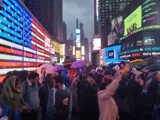 The crowd awaiting NASA TV footage to roll across the Nasdaq screen in Times Square.