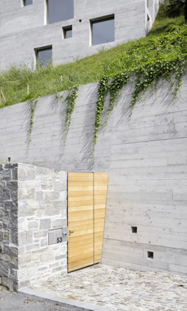 The structure encompasses three floors with the entrance at the lower part of the site