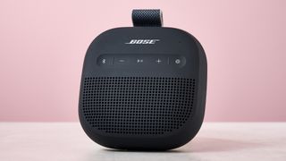Bose SoundLink Micro Gen 2 on table, against pink background