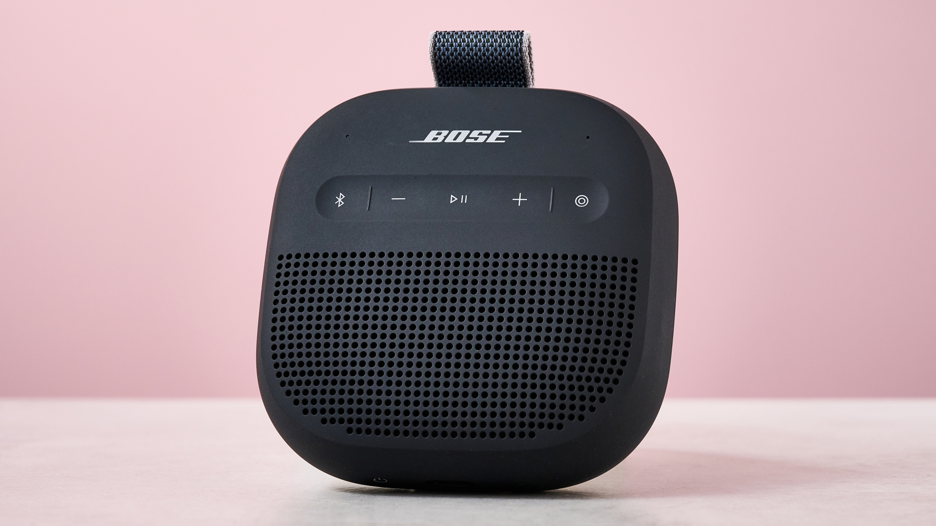 Bose SoundLink Micro Gen 2 on table, against pink background