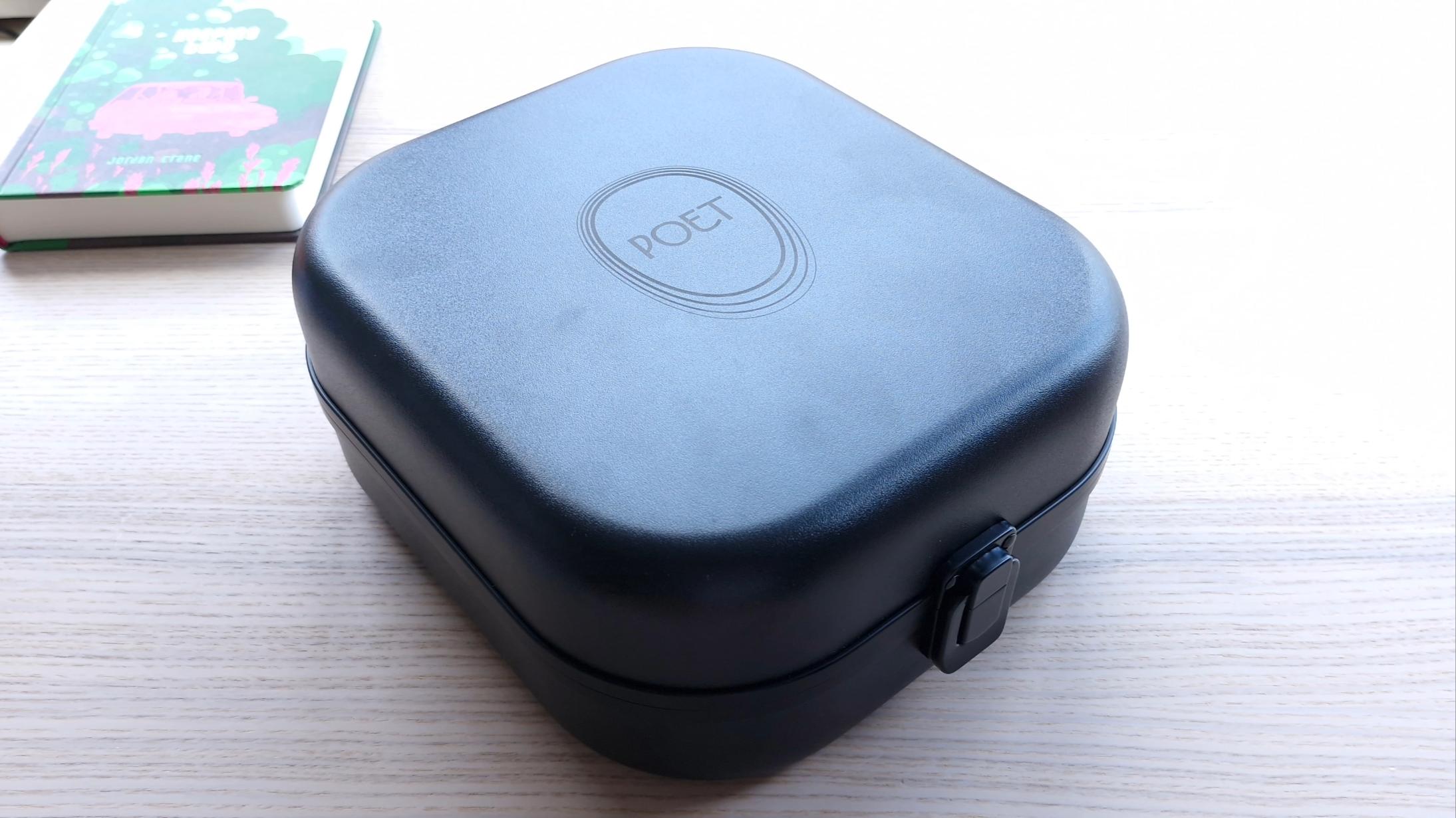 Carry case for Meze Audio Poet over-ear headphones on a wooden surface