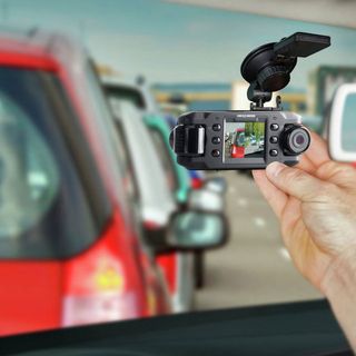 A NextBase dash cam mounted on a car windscreen